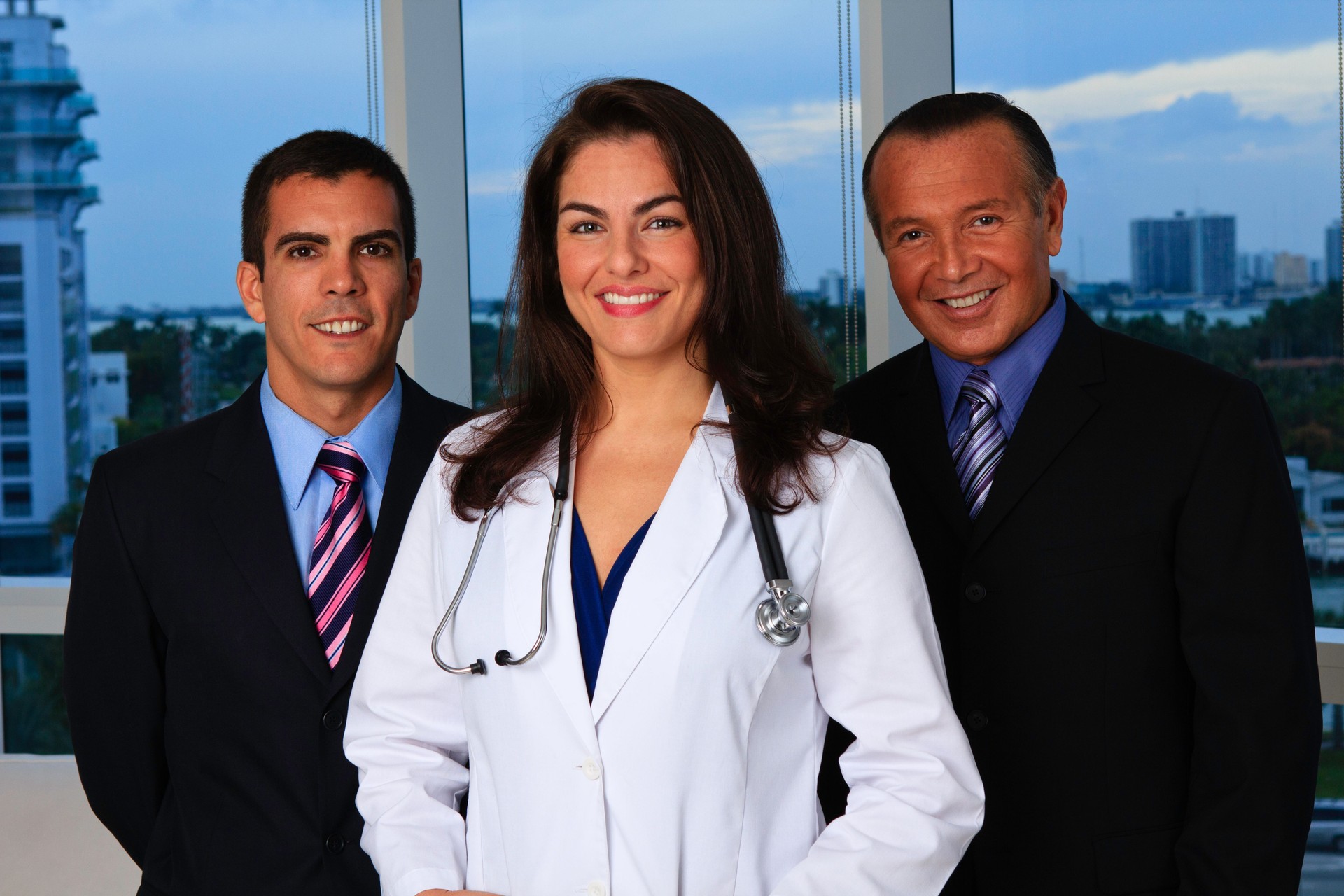 Female doctor and two businessmen in office